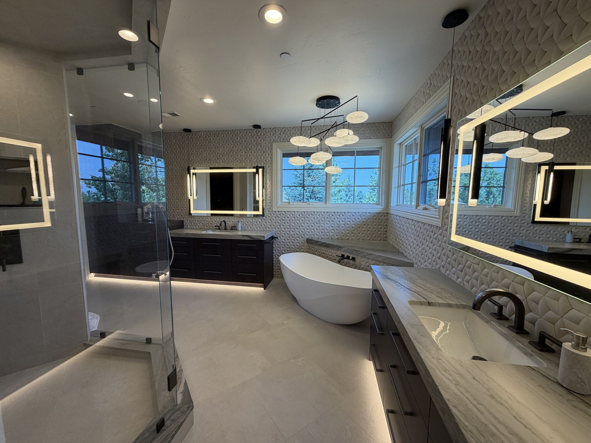 Finished bathroom with freestanding tub and sculpted tile by Revive Design Build