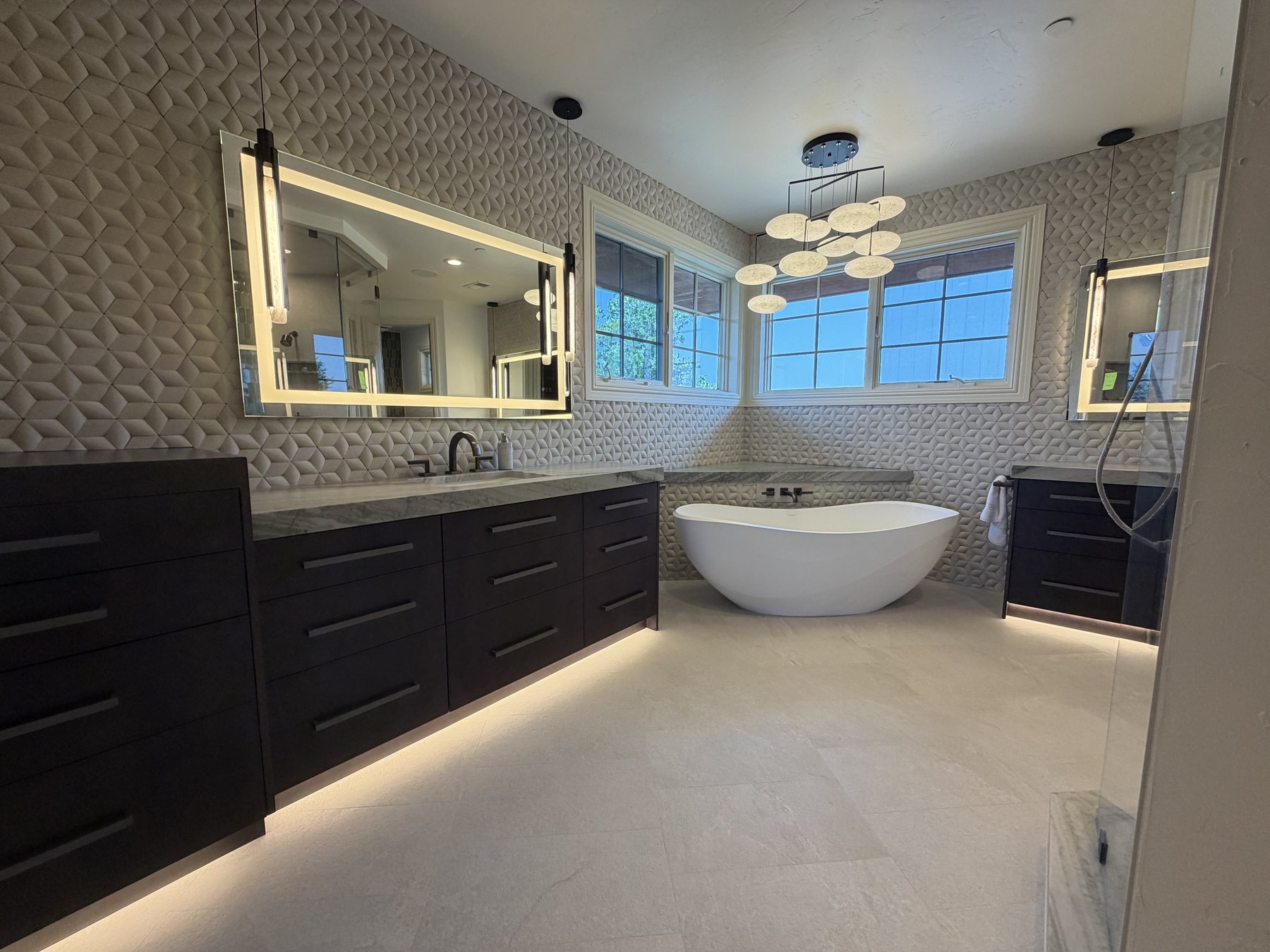 Completed bathroom with freestanding tub and sculpted tile